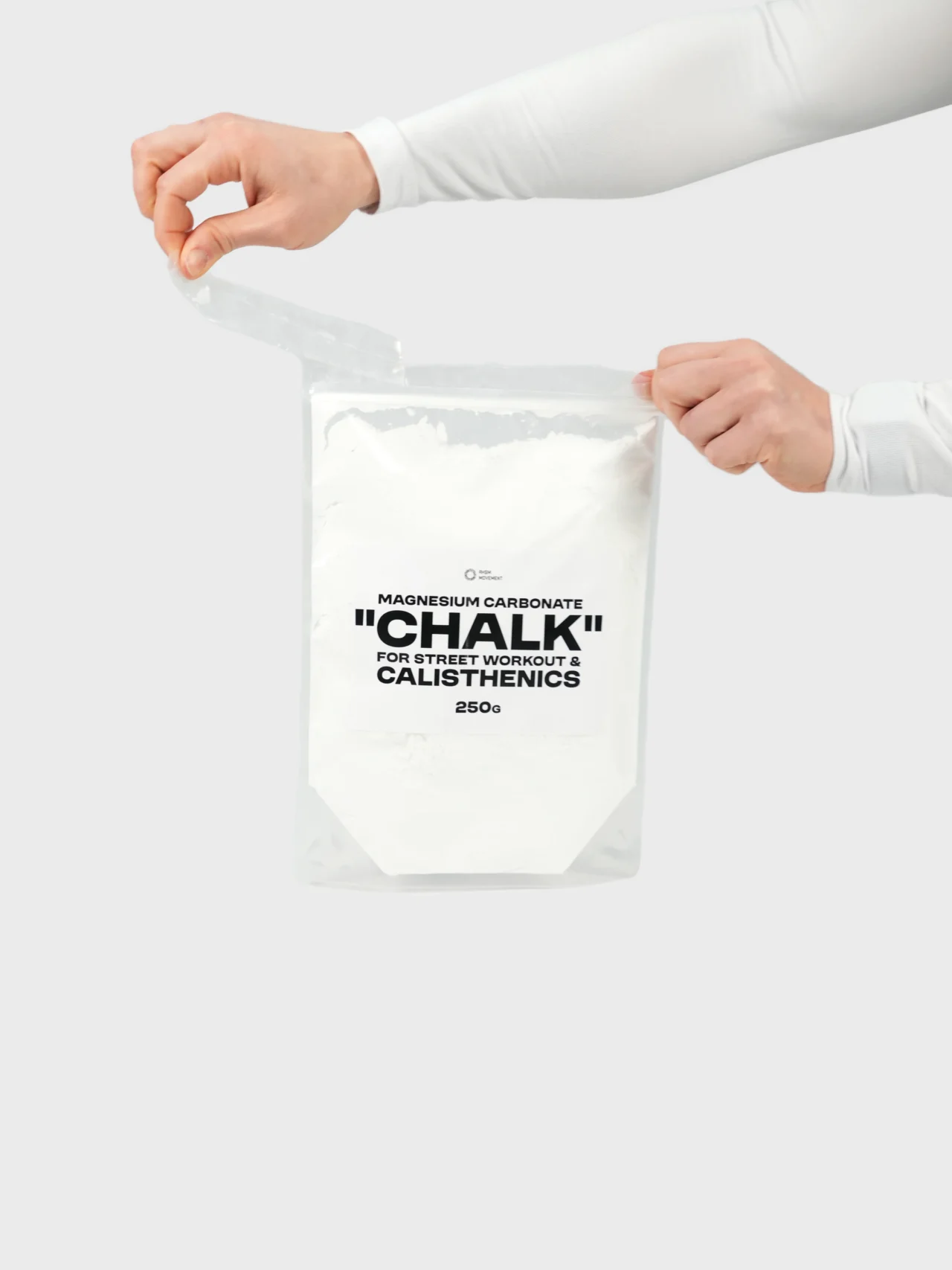 Athlete opening the resealable bag of RHSM calisthenics chalk, showcasing portable workout gear for street workout performance.