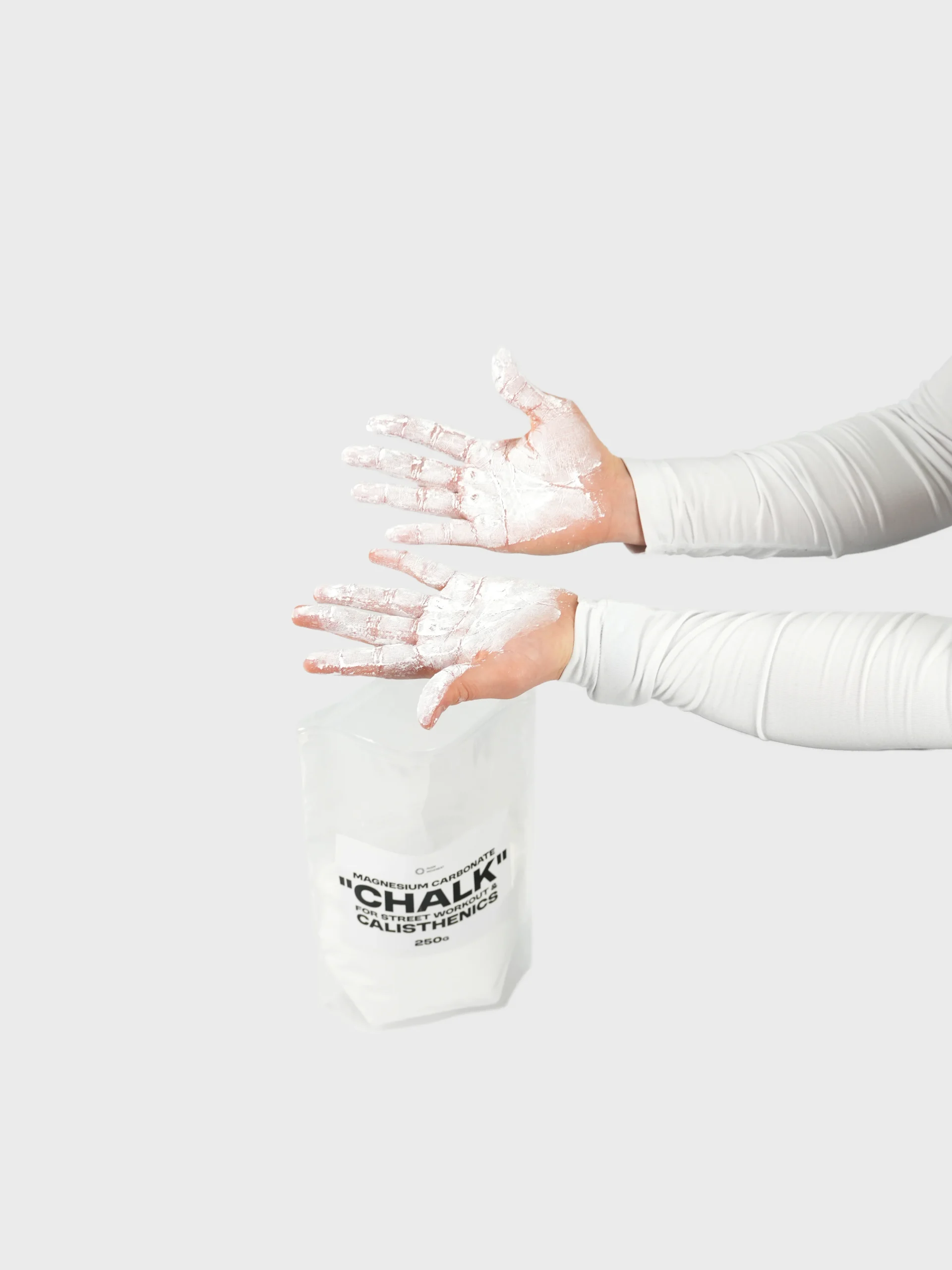 Both hands coated in RHSM magnesium carbonate chalk, demonstrating the elite grip provided by this calisthenics clothing brand accessory.